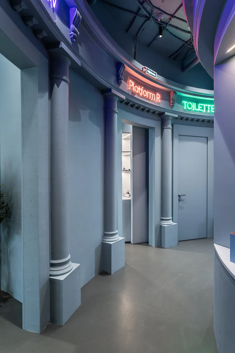 Colour-coded portals marking treatment platforms along the curved corridor