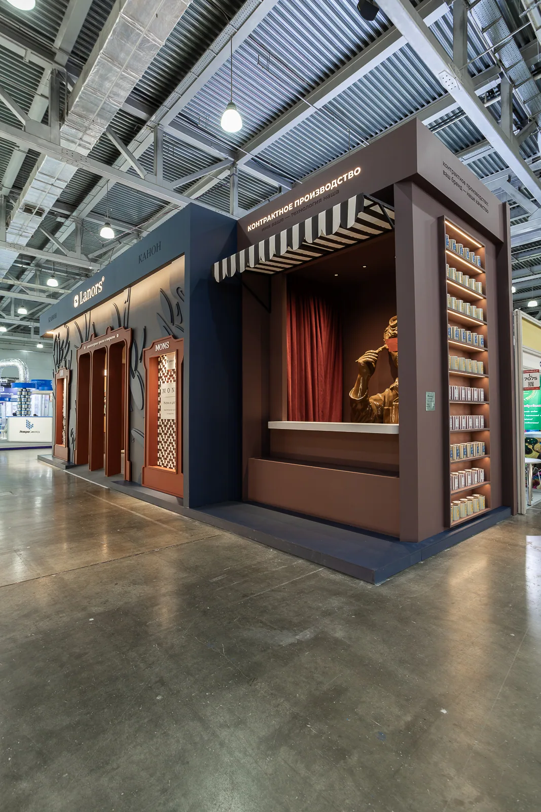 Second pavilion façade with a burgundy curtained opening and product wall