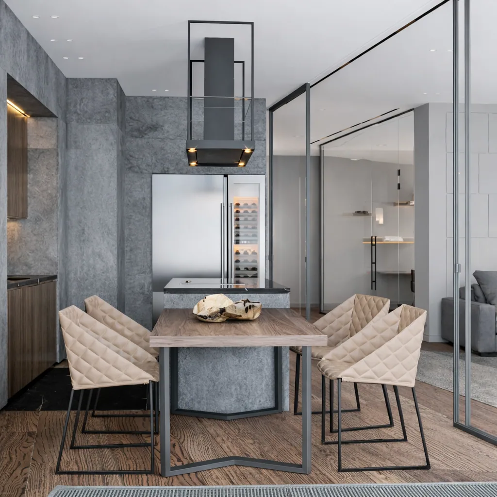 Round stone dining table beneath a glass display cabinet and linear pendant