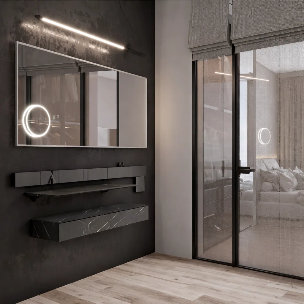 Dark stone vanity and circular illuminated mirror beside a glass partition