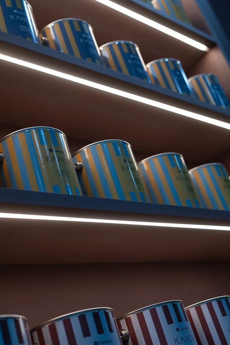 Rows of blue product packages displayed on illuminated burgundy shelves