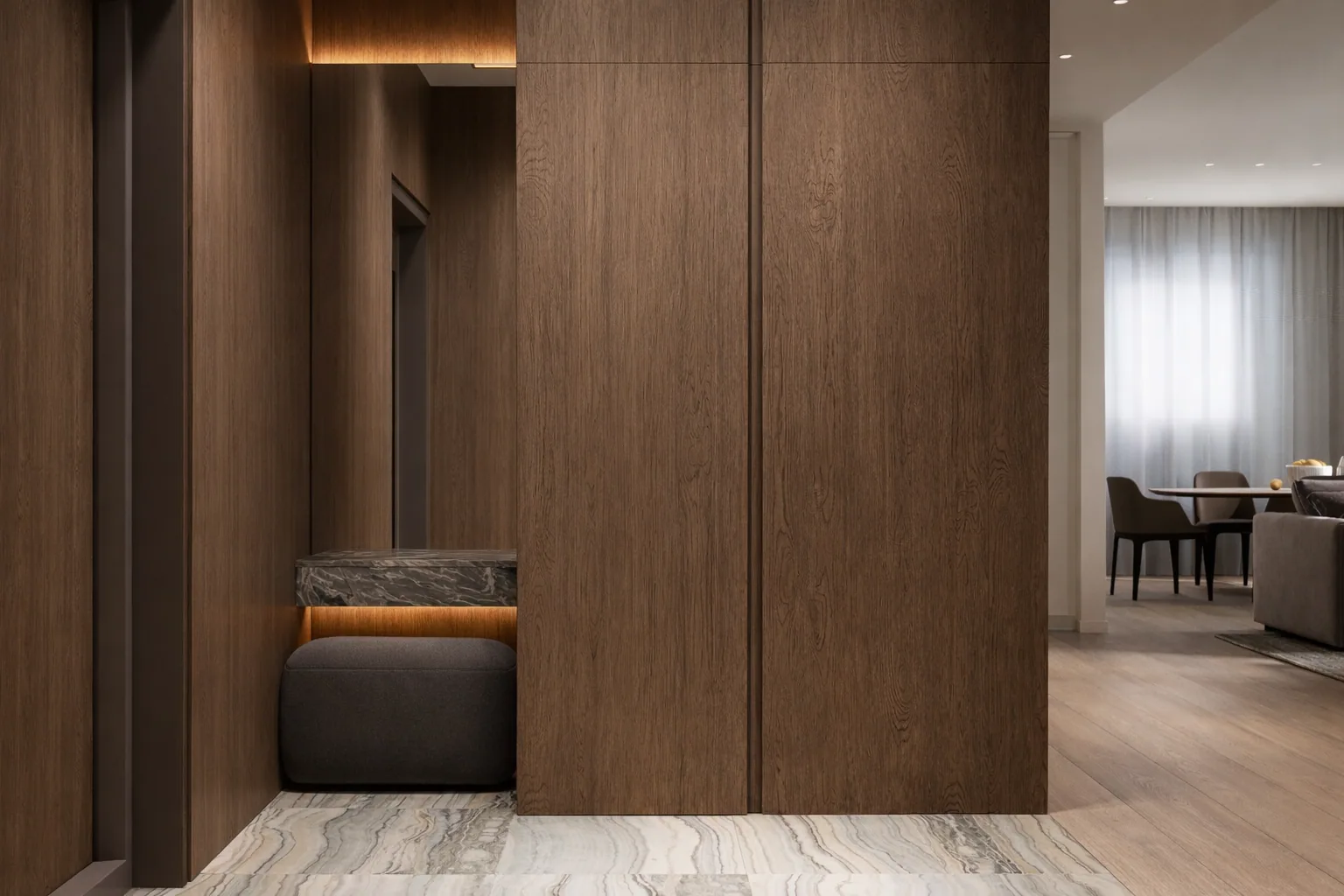 Entrance niche with an upholstered bench integrated into the timber panelling