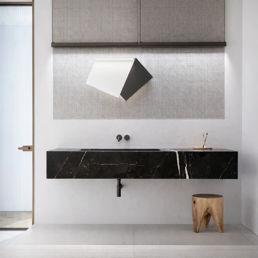 Minimal vanity with a floating black stone basin and angular mirror