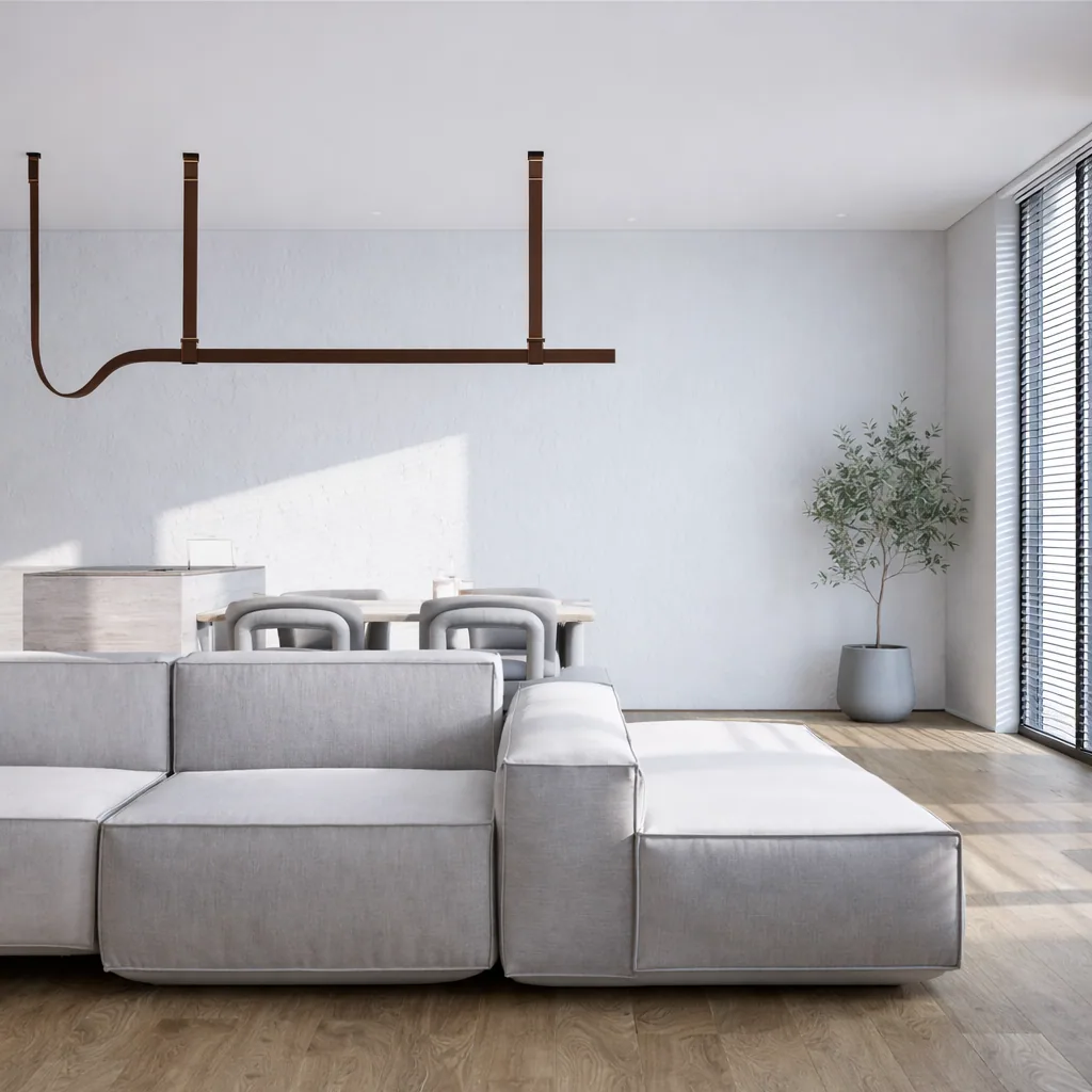 Soft modular sofa beneath a linear pendant in the light-filled living room
