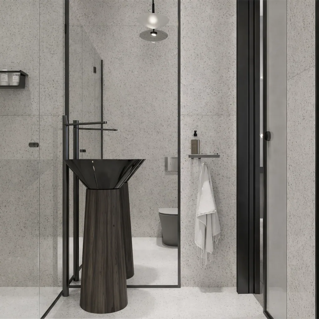 Glass shower enclosure with a dark sculptural basin and pendant light