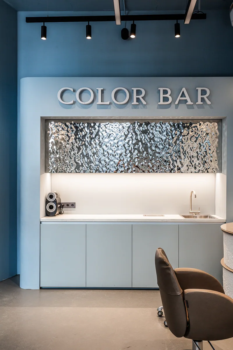 Colour Bar work station with blue cabinetry and a patterned metal backsplash