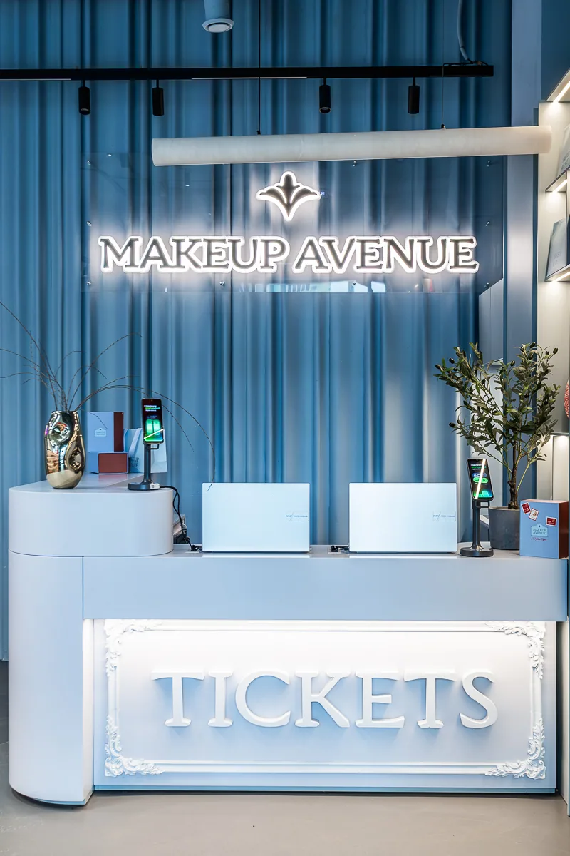 Makeup Avenue reception designed as an illuminated ticket counter