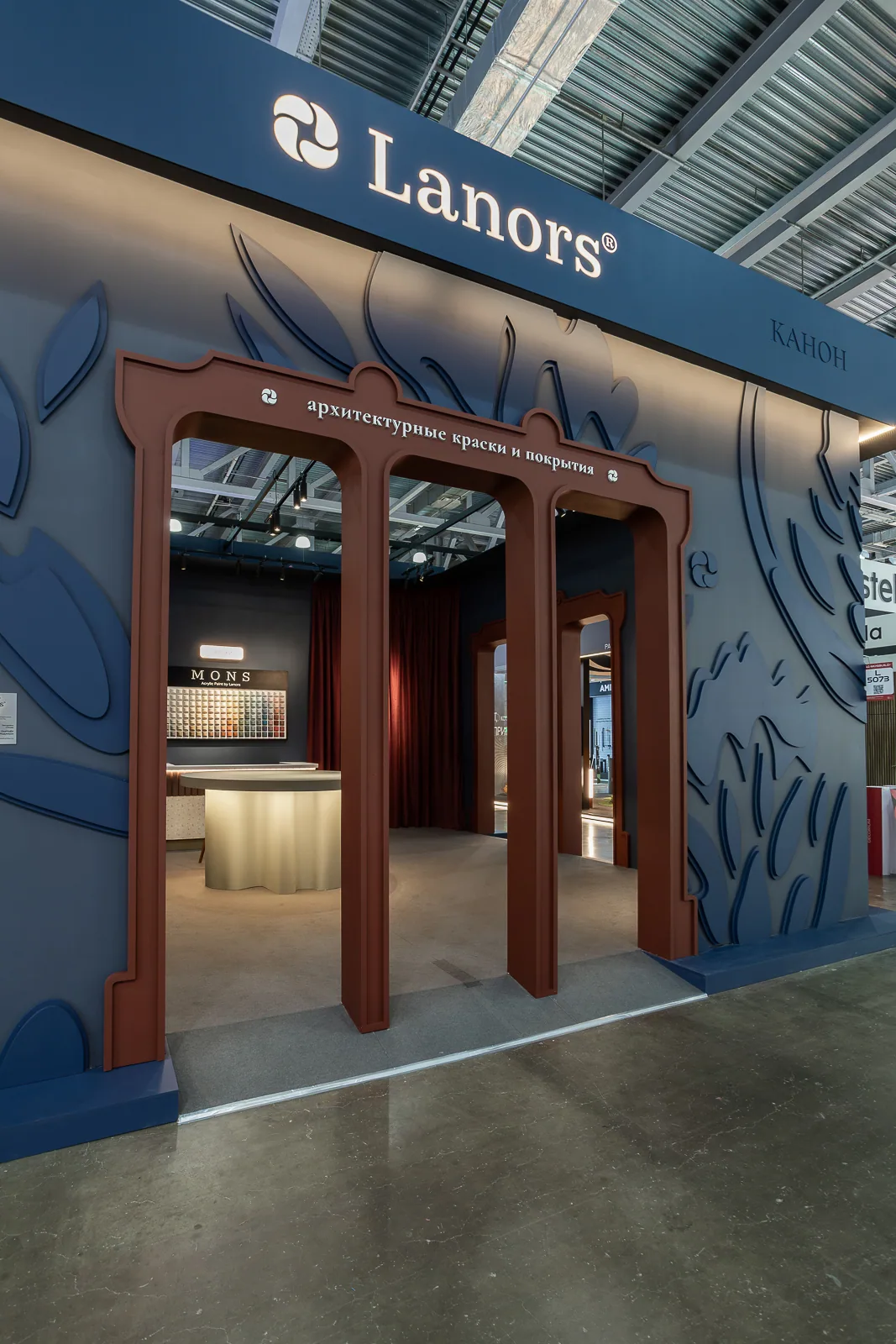 Triple entrance framed by blue relief walls and warm burgundy portals