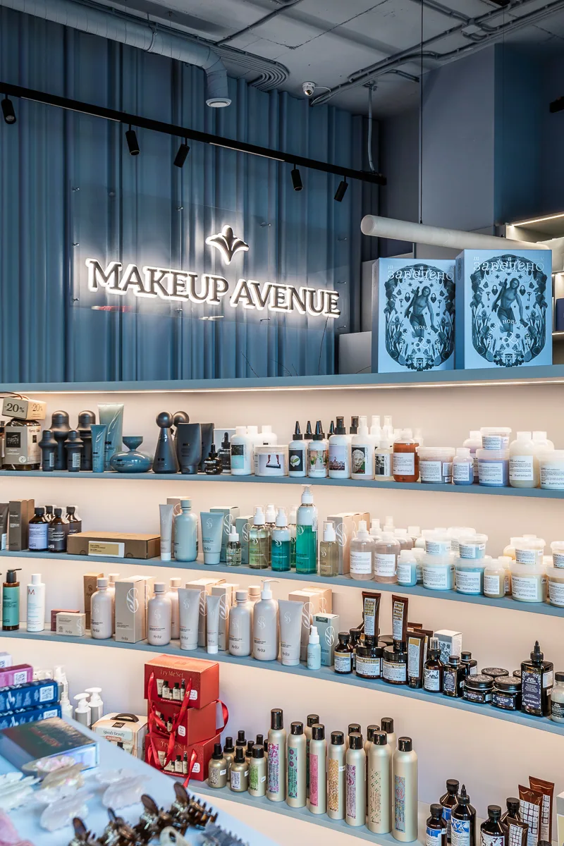 Wide Makeup Avenue product wall with integrated light and blue accents