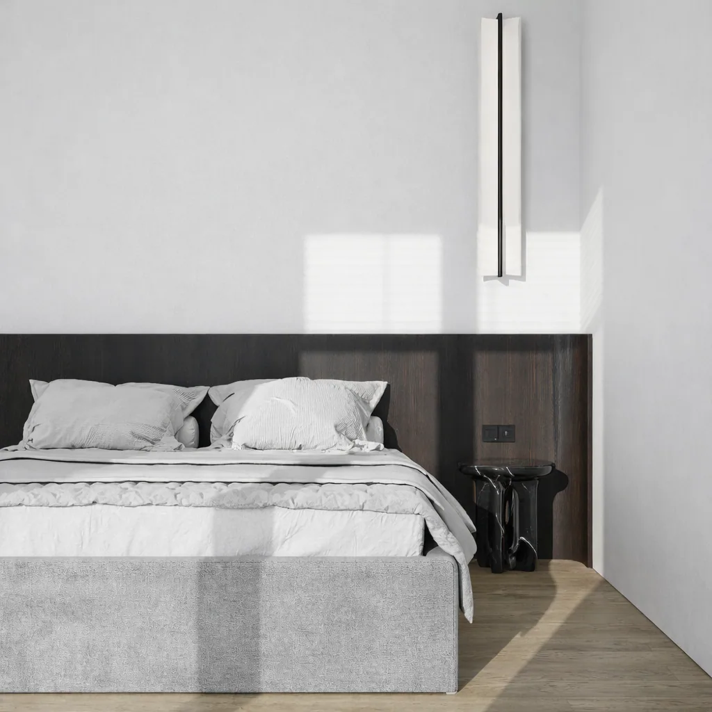 Bedroom with a low grey bed and a dark timber headboard wall