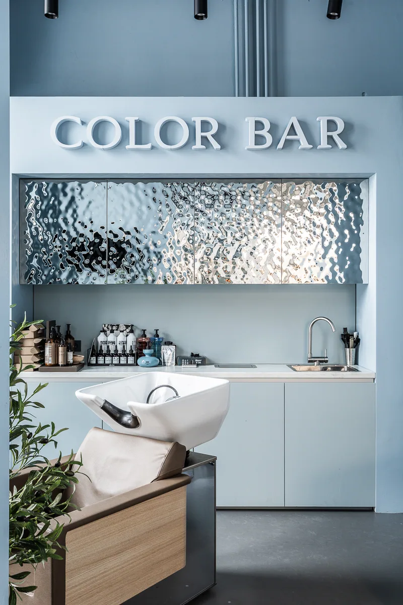 Colour Bar wash station beneath a textured metallic wall panel