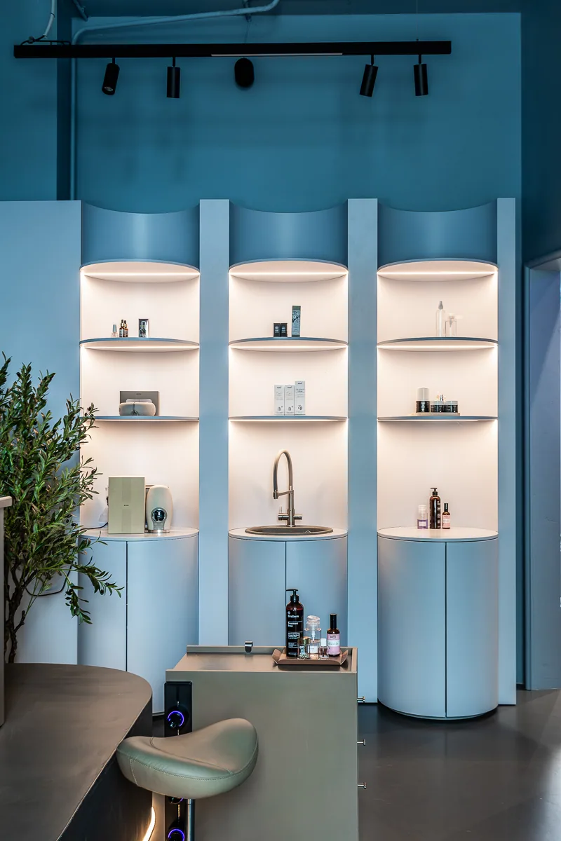 Pale blue arched display for beauty products and accessories