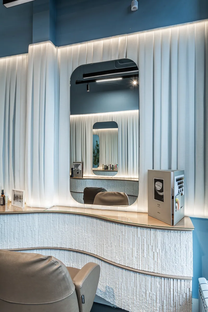 Centrale styling station with a softly curved illuminated wall