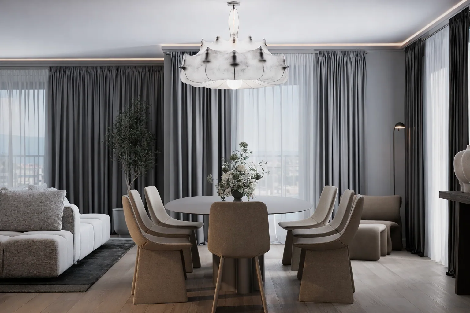 Living and dining room with layered grey textiles and full-height windows