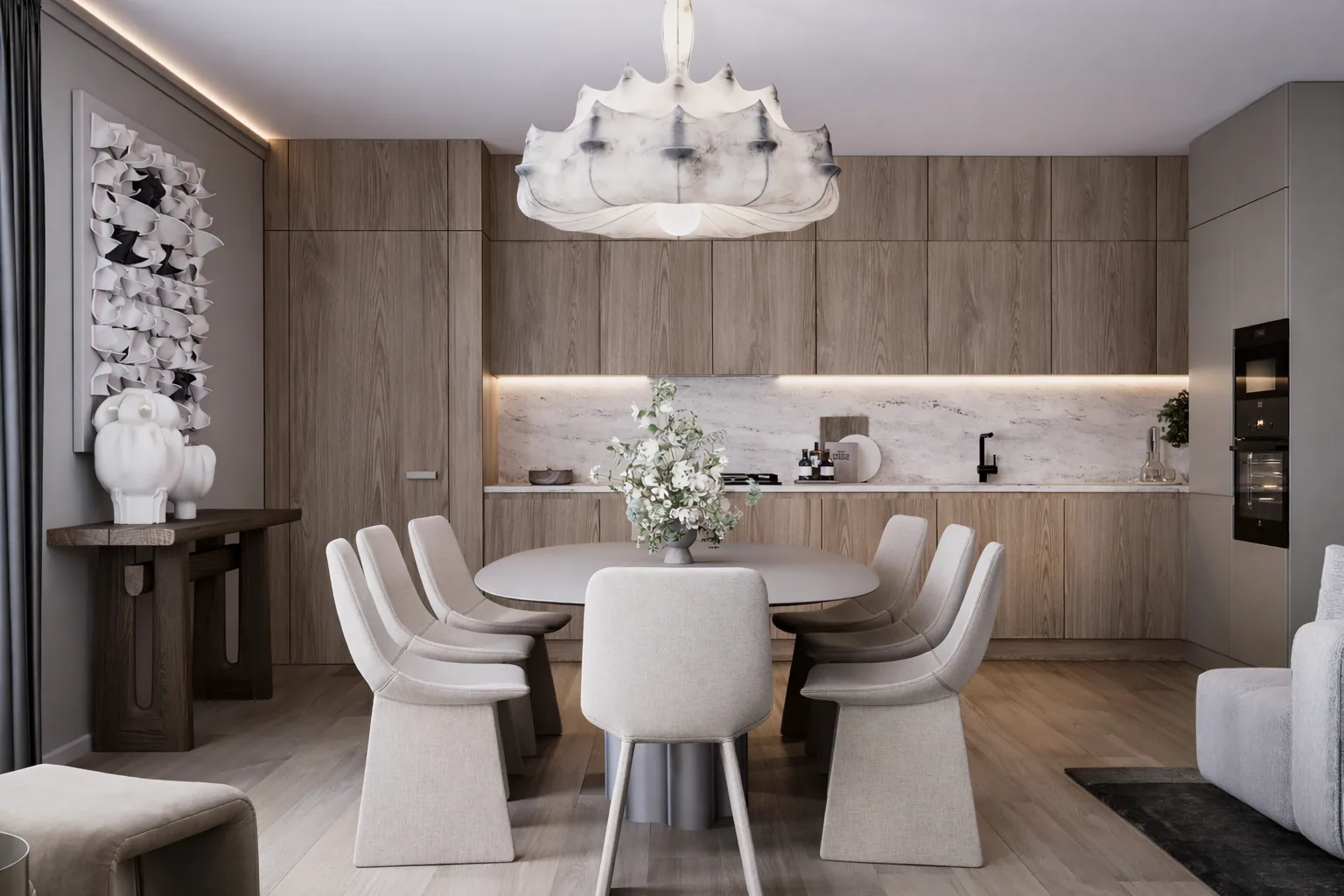 Open kitchen and dining area with pale timber joinery and a sculptural chandelier